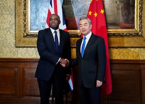 Britain's Foreign Secretary David Lammy (L)welcomes his Chinese counterpart Wang Yi ahead of a meeting at 1 Carlton Gardens in central London on Feb. 13, 2025.