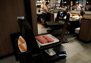 Robot serves food at a Haidilao hotpot restaurant in Singapore November 13, 2020. Picture taken November 13, 2020.