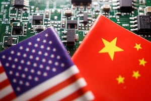 Flags of China and U.S. are displayed on a printed circuit board with semiconductor chips, in this illustration picture taken Feb. 17, 2023.