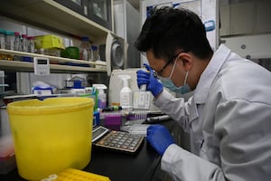 A laboratory technician works at a Tsinghua University lab in Beijing on Dec. 9, 2021.