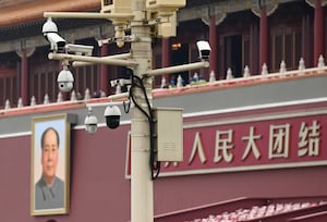 A closed-circuit cameras is seen on a pole near a portrait of Mao Zedong in front of the Tiananmen Gate, on June 24, 2021, in Beijing.