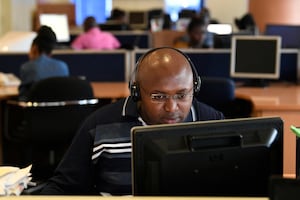 An NTV news reporter works at his desk in a newsroom of Kenyan 'Nation Media Group' (NMG) in Nairobi on January 19, 2018. The Chinese Embassy in Kenya has begun conducting media training in the country.