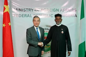 Chinese Foreign Minister Wang Yi (L) shakes hands with Nigeria's Foreign Affairs Minister Yusuf Tuggar (R) during Minister Wang's diplomatic visit to Abuja in January, 2025.