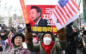 Supporters of South Korea President Yoon Suk Yeol hold placards showing a picture of Yoon during a rally near the Constitutional Court in Seoul on Feb. 25, 2025, as Yoon is scheduled to attend his final impeachment hearing.