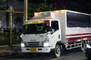 A Thai immigration department truck, with windows covered, leaves Bangkok's main immigration detention center in the early hours of Feb. 27, 2025