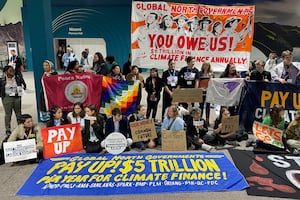 Activists hold a silent protest inside the COP29 venue to demand that rich nations provide climate finance to developing countries, during the United Nations Climate Change Conference (COP29) in Baku on November 16, 2024.