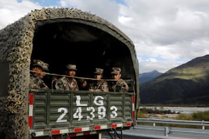 Chinese soldiers of the People's Liberation Army sit in a truck on the highway to Nyingchi, Tibet Autonomous Region, China, Oct. 19, 2020.